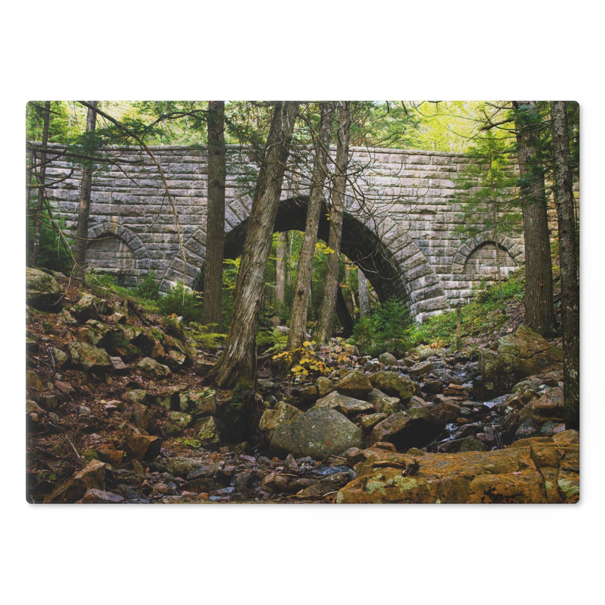 Tempered Glass Cutting Board showing Hemlock Bridge on Acadia’s historic Carriage Roads, surrounded by evergreen forest. Inspired by Rockefeller’s nature-focused design.